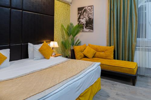 a hotel room with a bed and a couch at Square Boutique Hotel in Baku