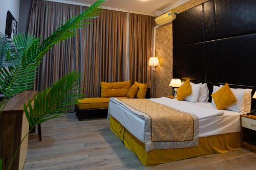 a hotel room with a bed and a couch at Square Boutique Hotel in Baku