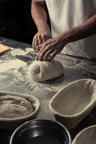 a person kneading a piece of dough on a table at Agriturismo Emidio Pepe in Torano Nuovo