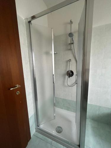 a shower with a glass door in a bathroom at Locazione Turistica Mario Colucci in Verona