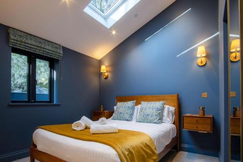 a bedroom with a bed with towels on it at Ty Alice - 3 Bedroom Cottage - Bayview Oxwich in Oxwich