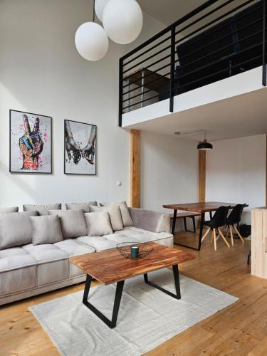 a living room with a couch and a table at spacious modern LOFT, 2 bedrooms, 95m2, free parking in Bratislava