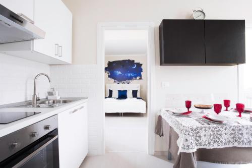 a kitchen with a table with red wine glasses on it at Tourist House Bologna - Self check-in in Bologna