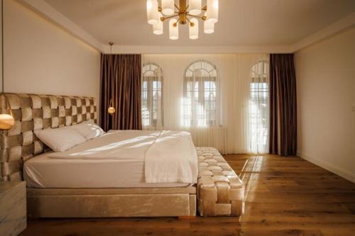 a bedroom with a large bed and a chandelier at Villa The Boutique Cappadocia in Urgup