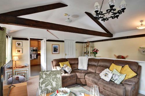 a living room with a couch and a table at Finest Retreats - Dales Barn Top in Hawes
