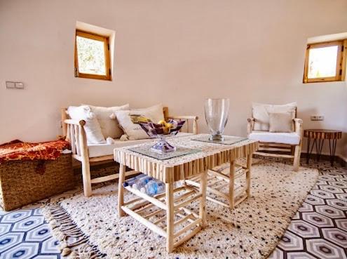 a living room with a couch and a table at Villa Roswell Marrakech in Marrakech