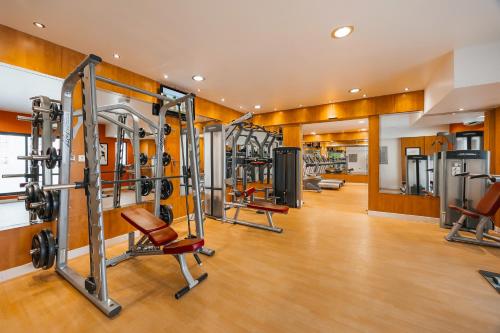 a gym with several tread machines in a room at Golden Sands Bur Dubai in Dubai