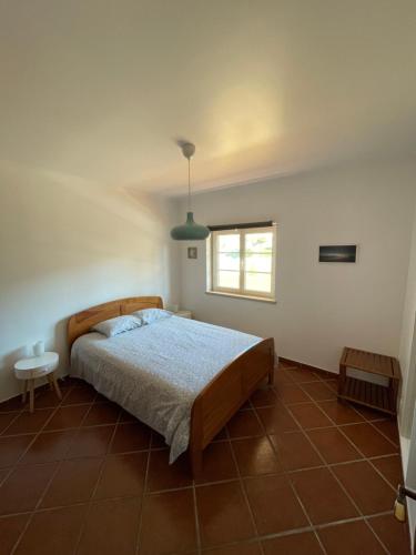 a bedroom with a bed and a window at Ericeira Beach House in Ericeira