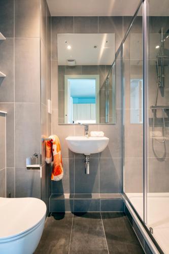a bathroom with a sink and a shower and a toilet at Luxury Studio Apartments in Cork City Centre in Cork