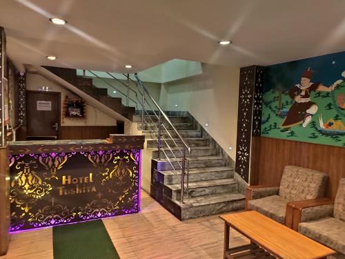 a lobby with stairs and a sign that reads hotel tbilisi at KG Tusheta - 200 mtrs from MG Marg in Gangtok