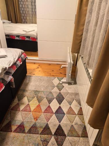 a room with a rug on the floor next to a door at Къща Томови in Devin