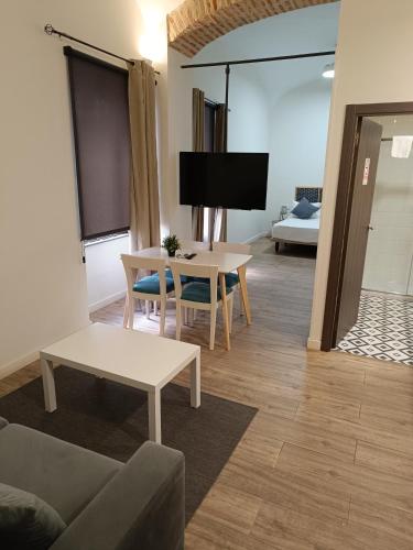 a living room with a couch and a table at Apartamentos AL-QAZERES LUXURY La Concepción in Cáceres