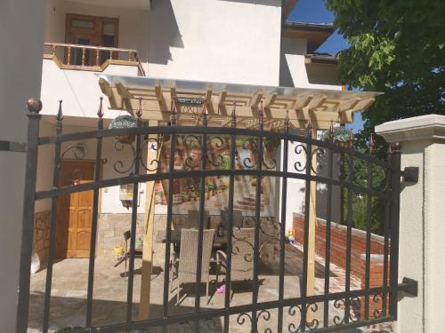 a gate to a house with a fence at Къща Томови in Devin