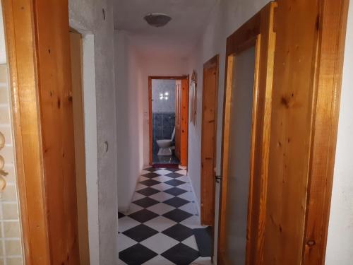 an empty hallway with a toilet in a room at Къща Томови in Devin