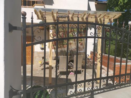 a gate to a patio with a table and chairs at Къща Томови in Devin