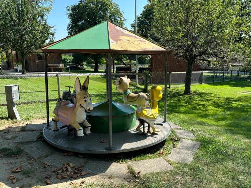 a toy carousel with two toy animals on it at Wirtshaus Rütihof in Gränichen