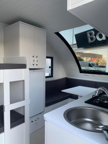 a kitchen with a sink and a counter top at Caravan suit in Bitlis