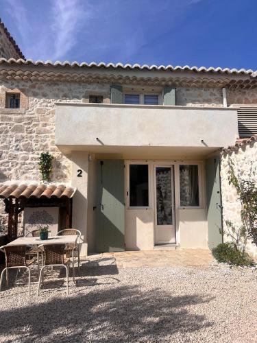 a house with a table and chairs in front of it at La Bohème Mouriès in Mouriès