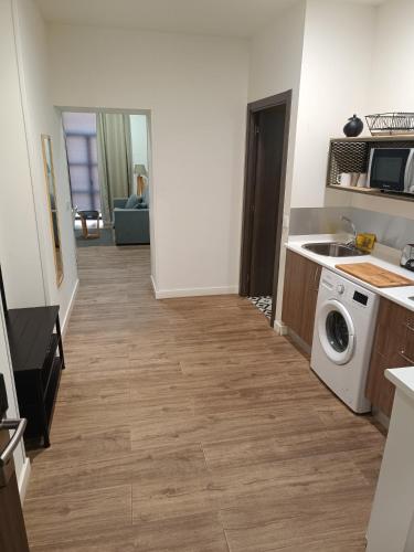 a kitchen with a washer and dryer in a room at Apartamentos AL-QAZERES LUXURY La Concepción in Cáceres