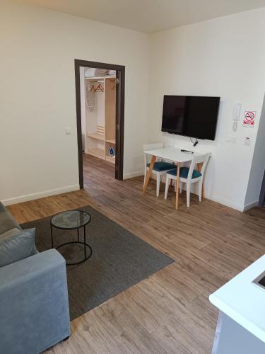 a living room with a couch and a table at Apartamentos AL-QAZERES LUXURY La Concepción in Cáceres