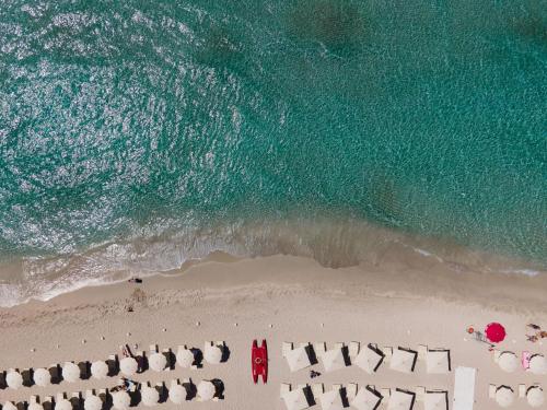 an overhead view of a beach with chairs and the ocean at Tenuta del Barco WineRestaurant and Hospitality in Pulsano