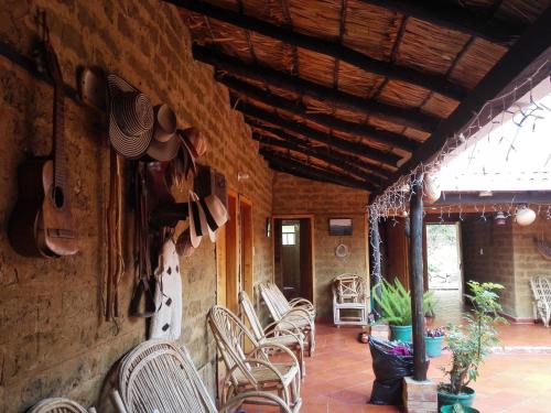 a room with chairs and hats on the wall at Monzaque- paraíso de bachué in El Barrial