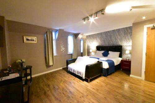 a hotel room with a bed and a couch at The Royal Hotel Cardiff in Cardiff
