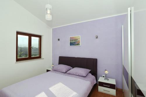 Säng eller sängar i ett rum på Apartments Maslina Božava