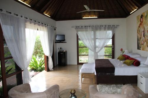 a bedroom with a bed and a living room at Chuiba Bay lodge in Pemba