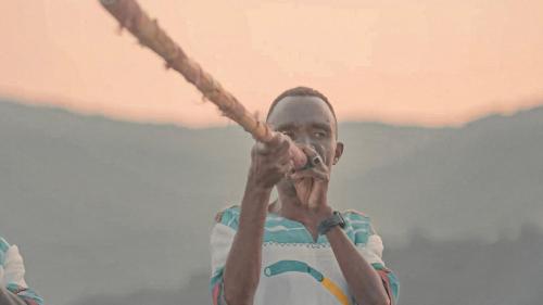 a man holding a stick in his hands at Chebera Elephant Paw Lodge in Bokdē