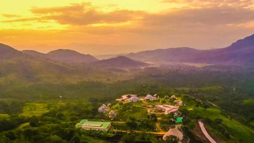 an aerial view of a resort with mountains in the background at Chebera Elephant Paw Lodge in Bokdē