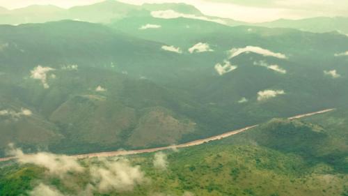 an aerial view of a mountain range with a road at Chebera Elephant Paw Lodge in Bokdē