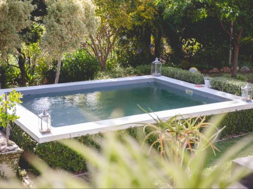 a swimming pool in a garden with trees at Croxley Farm in Robertson