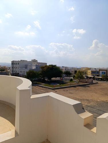 a white wall with a view of a city at Leyla Hostel in Mawāliḩ