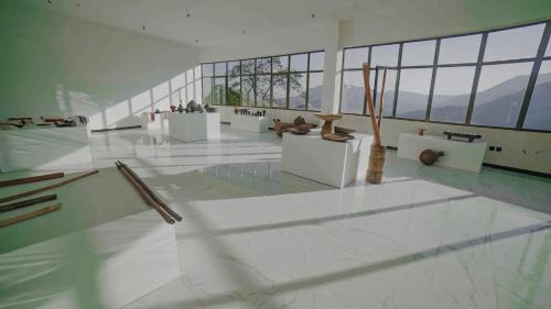 a large room with white floors and large windows at Chebera Elephant Paw Lodge in Bokdē