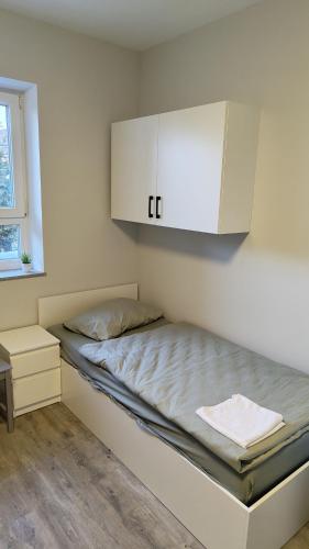 a bedroom with a bed with a white cabinet at Apartment for 3 guests in Geesthacht