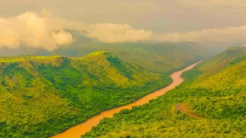an aerial view of a river between two mountains at Chebera Elephant Paw Lodge in Bokdē