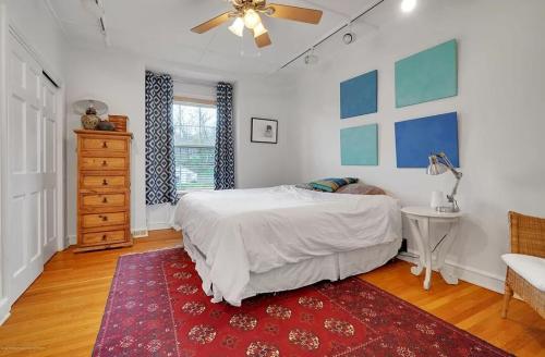 a bedroom with a bed and a table and a ceiling fan at Stunning, Large, Waterfront Retreat in Highlands