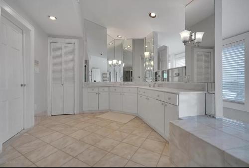 a large bathroom with white cabinets and a large mirror at Stunning, Large, Waterfront Retreat in Highlands