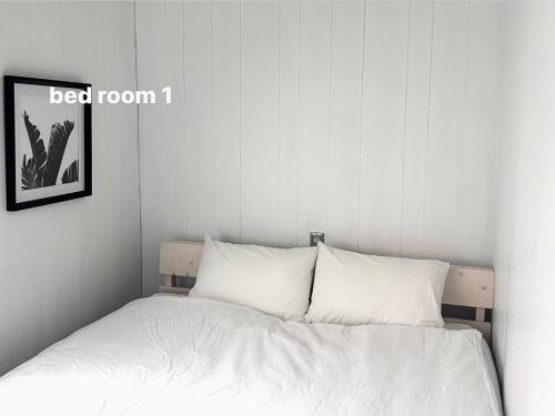 a bed with white sheets and pillows in a bedroom at Vacation House Day in Naoshima
