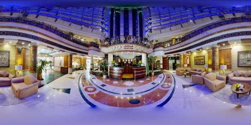 a large lobby with couches and chairs in a building at Al Muna Kareem Hotel- EX LEADER in Al Madinah