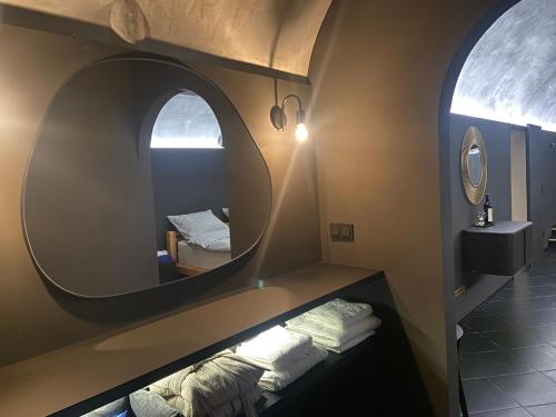 a bathroom with a mirror and towels on a shelf at UrbanSpa - Prague 1 in Prague