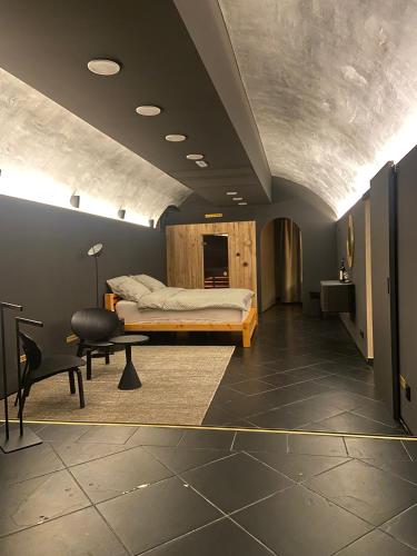 a bedroom with a bed and a desk and a chair at UrbanSpa - Prague 1 in Prague