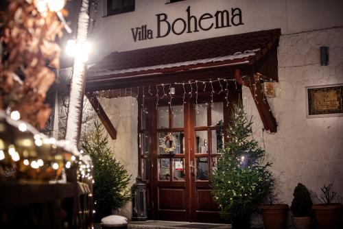 a door to a wine store with christmas trees outside at Hotel Villa Bohema in Kazimierz Dolny