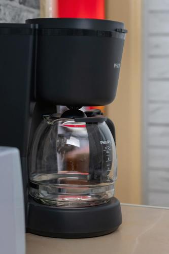 a black coffee maker sitting on top of a counter at Spacious Studio with Balcony in Katowice by Noclegi Renters in Katowice