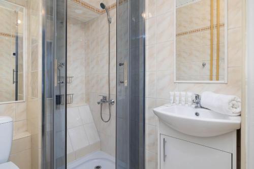 a bathroom with a shower and a sink and a toilet at Spacious Studio with Balcony in Katowice by Noclegi Renters in Katowice