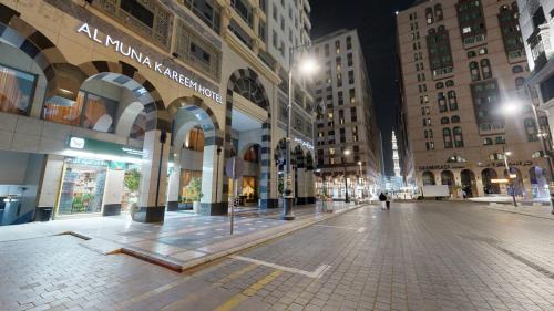 an empty street in a city at night at Al Muna Kareem Hotel- EX LEADER in Al Madinah