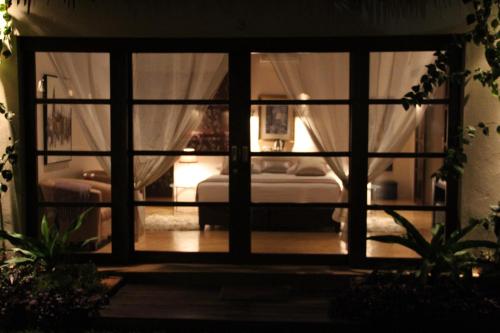 a view of a bedroom through a glass door at Chuiba Bay lodge in Pemba