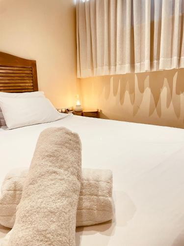 a bedroom with a white bed and a chair at Nastasi Hotel & Spa in Lleida