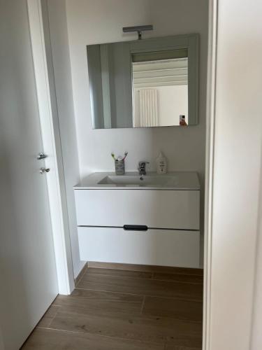a bathroom with a sink and a mirror at House on the beach Varigotti in Varigotti